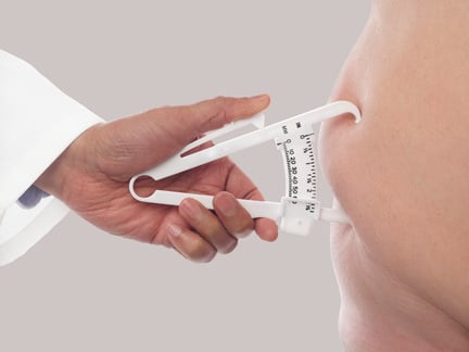 Doctor Using a Skin Fold Caliper to Measure Body Fat